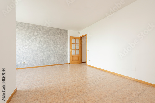 Empty room with two-tone painted walls, stoneware floors and oak carpentry