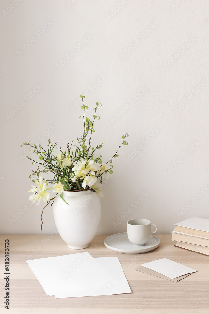 custom made wallpaper toronto digitalFloral still life. Easter bouquet. Wite, yellow tulips, daffodils flowers. Green birch tree, blueberry branches in ceramic vase pot on wooden table. Vertical. Blank paper cards mockups, cup of coffee