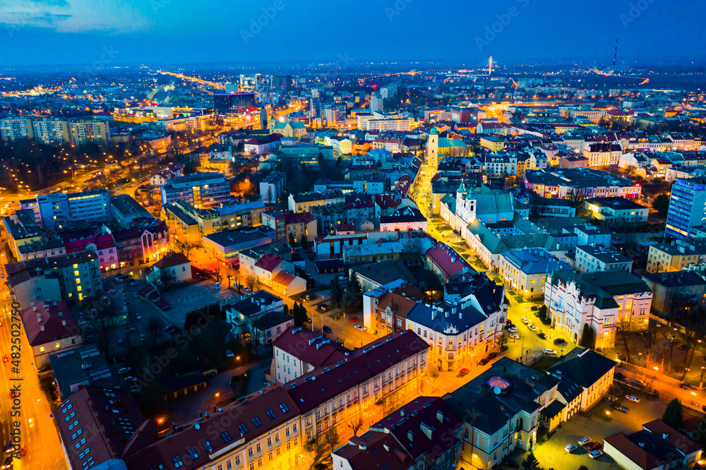 Fototapeta premium Aerial view of illuminated streets and buildings at night, Rzeszow, Poland