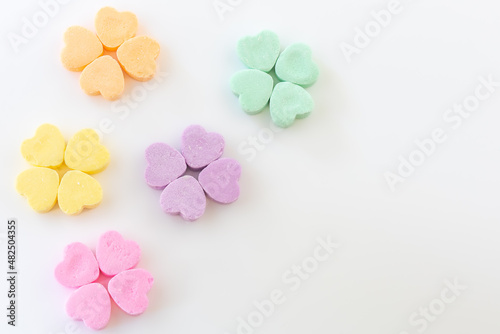 Conversation hearts on white background flat lay.