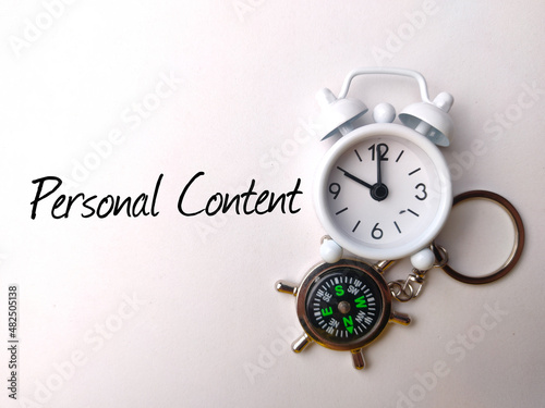 Top view compass and calculator with text Personal Content on white background.