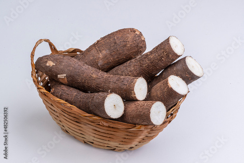 Cassava in basket on white background.