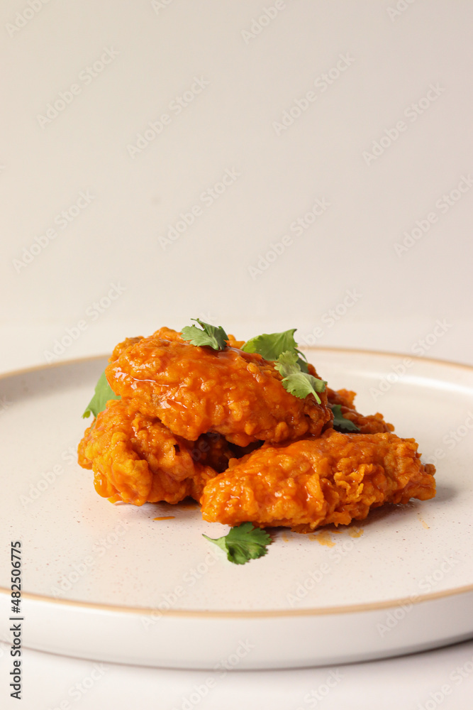 spicy buffalo wing on a plate served gourmet decorated with coriander leaves spicy buffalo wing on a plate served gourmet decorated with coriander leaves