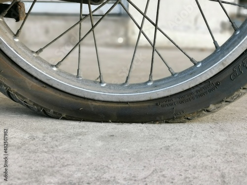 Close up image flat tyre of motocycle. photo