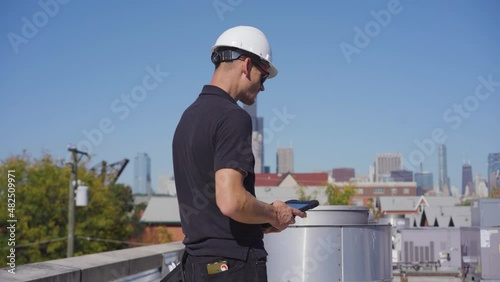 Inspector performing an HVAC unit inspection on a commercial building