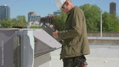 Wallpaper Mural Inspector performing an HVAC unit inspection on a commercial building Torontodigital.ca