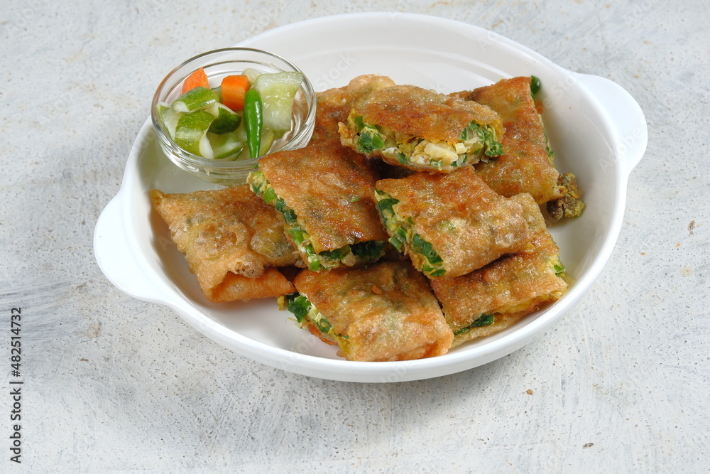 Martabak Telur or omelette murtabak, savory pan-fried pastry stuffed with egg, meat and spices with kari sauce,is an Indonesia traditional street food