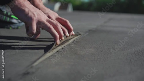 Inspector performing a roof membrane inspection on a commercial building