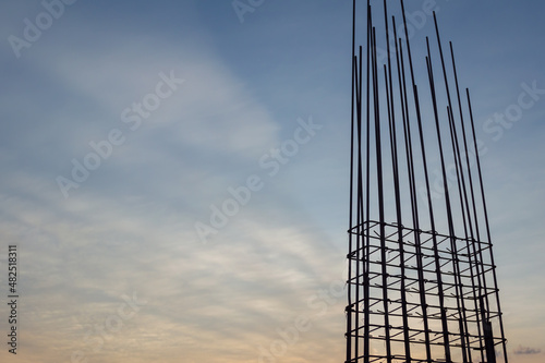 Steel reinforce in concrete column.Steel grid on the construction site.Reinforcement of concrete work. Using steel wire for securing steel bars with wire rod for reinforcement of concrete at sunset