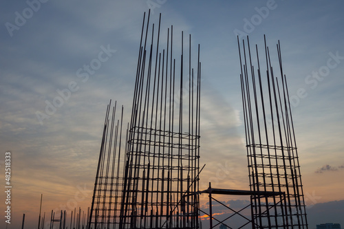 Steel reinforce in concrete column.Steel grid on the construction site.Reinforcement of concrete work. Using steel wire for securing steel bars with wire rod for reinforcement of concrete at sunset