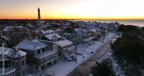 Cape May Point New Jersey. Lighthouse and vacation homes at sunrise, sunset. Winter snow. photo
