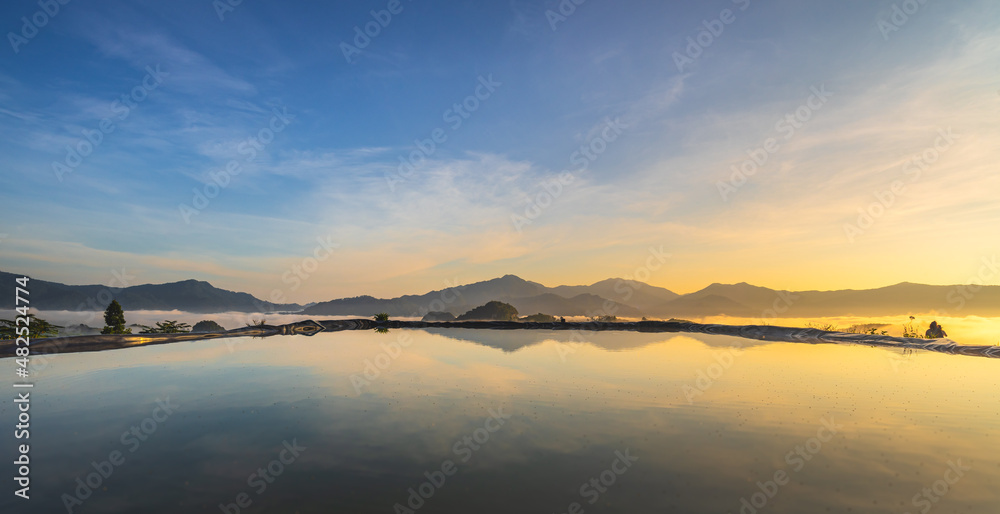 Sunrise over the mountain range with pond on peak of mountain and amazing landscape, Sea of mist in Tropicana rainforest south east Asia landscape. southern Thailand, outdoor and camping in morning.