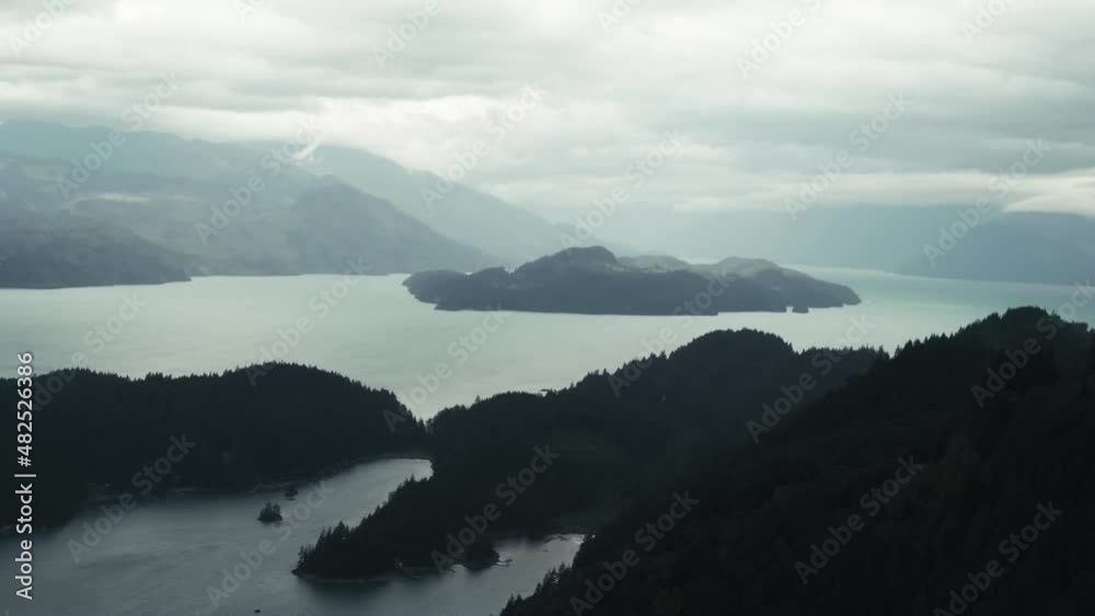 Calm Lake And Mountains In Fog In The Countryside Of British Columbia, Canada At Sunrise. wide aerial Calm Lake And Mountains In Fog In The Countryside Of British Columbia, Canada At Sunrise. wide aerial