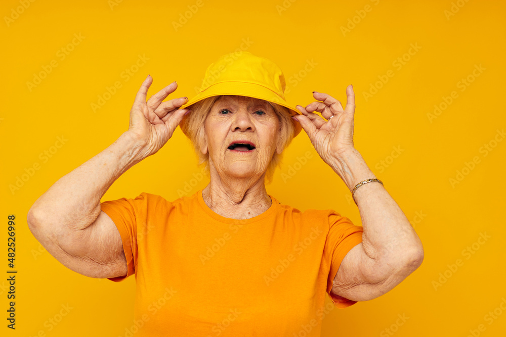 smiling elderly woman in casual t-shirt yellow panama cropped view smiling elderly woman in casual t-shirt yellow panama cropped view