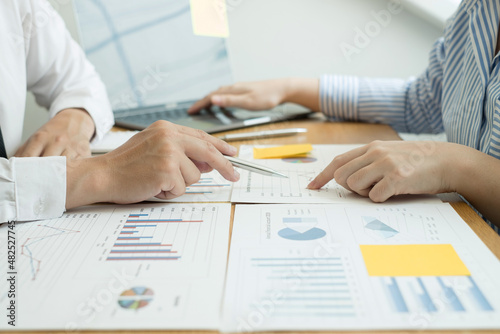 Two business leaders talk about charts, financial graphs showing results are analyzing and calculating planning strategies, business success building processes