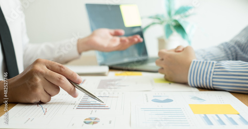 Two business leaders talk about charts, financial graphs showing results are analyzing and calculating planning strategies, business success building processes