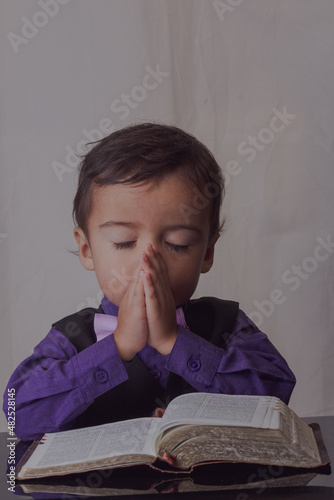 portrait of little man reading the word of God