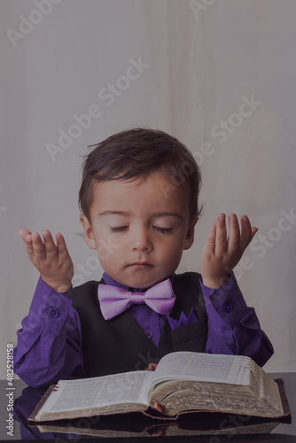 portrait of little man reading the word of God