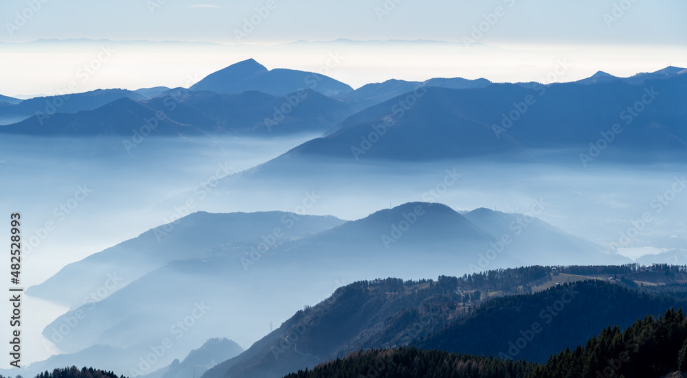 Great landscape at hills and mountains with humidity and pollution in the air. Landscape from Monte Pora, Italy. Alpine view