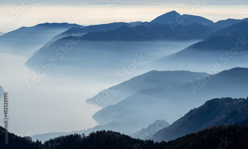 Great landscape at lake Iseo in winter season. Foggy and humidity in the air. Panorama from Monte Pora, Italian Alps, Italy