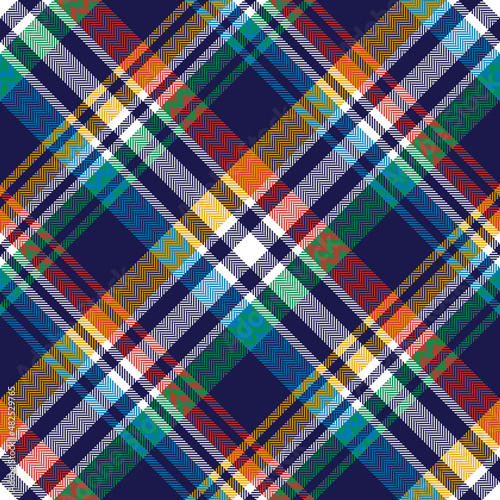 Plaid pattern in colorful navy blue, red, green, yellow, white. Seamless diagonal herringbone large tartan check for flannel shirt, scarf, blanket, duvet, other spring summer autumn winter design.