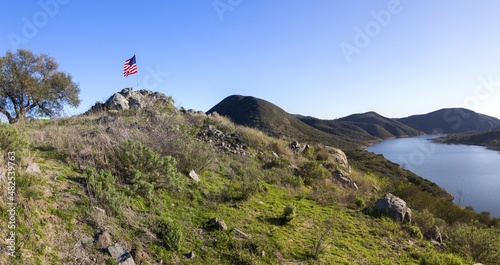 Scenic View of Beautiful Lake Hodges in San Dieguito River Park, Southern California from Fletcher Point Peninsula with American Flag on Highest Point photo