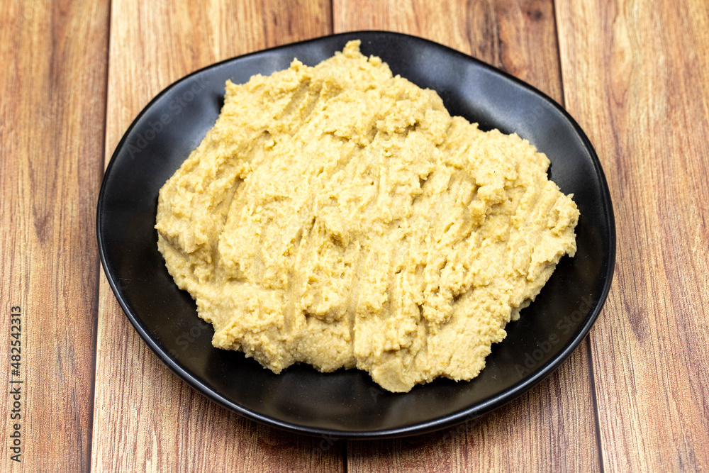 Hummus in a ceramic plate. Dishes of chickpeas, a vegetarian dish. Hummus in a ceramic plate. Dishes of chickpeas, a vegetarian dish.