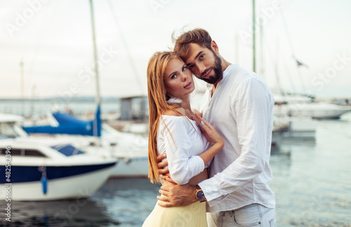 Beautiful couple in love spending time together in the yacht club