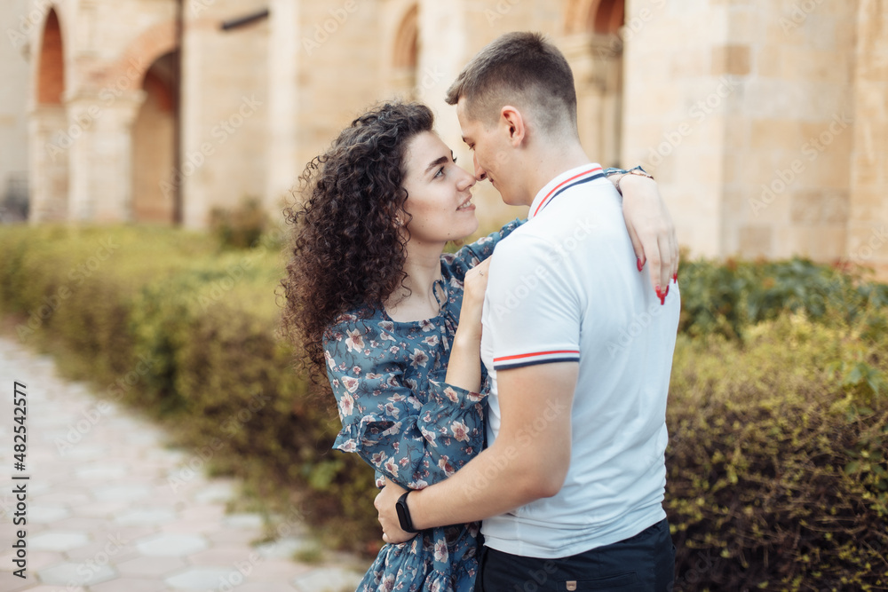 Young couple in love hug in a European city. Feeling in love, romantic concept