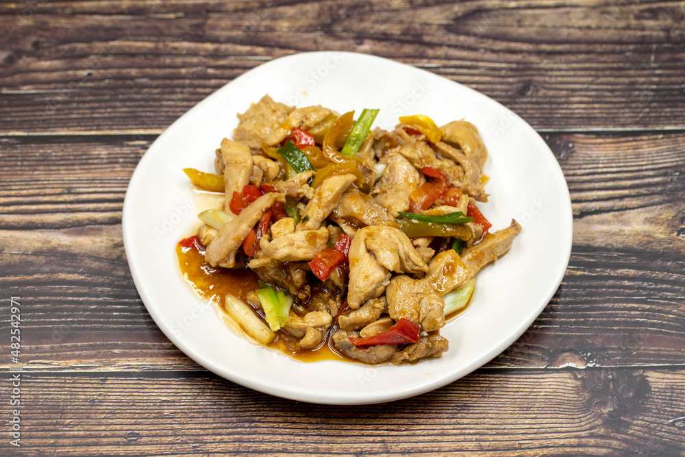 Chinese chicken dish. Chicken with olive oil and soy sauce. Traditional Chinese dish prepared with garlic, onion, capia pepper and green pepper Chinese chicken dish. Chicken with olive oil and soy sauce. Traditional Chinese dish prepared with garlic, onion, capia pepper and green pepper