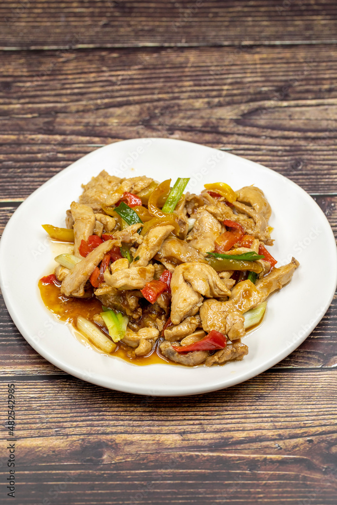 Chinese chicken dish. Chicken with olive oil and soy sauce. Traditional Chinese dish prepared with garlic, onion, capia pepper and green pepper