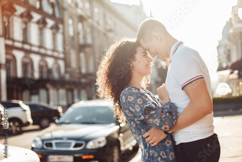 Young couple in love in the city look at each other in love photo