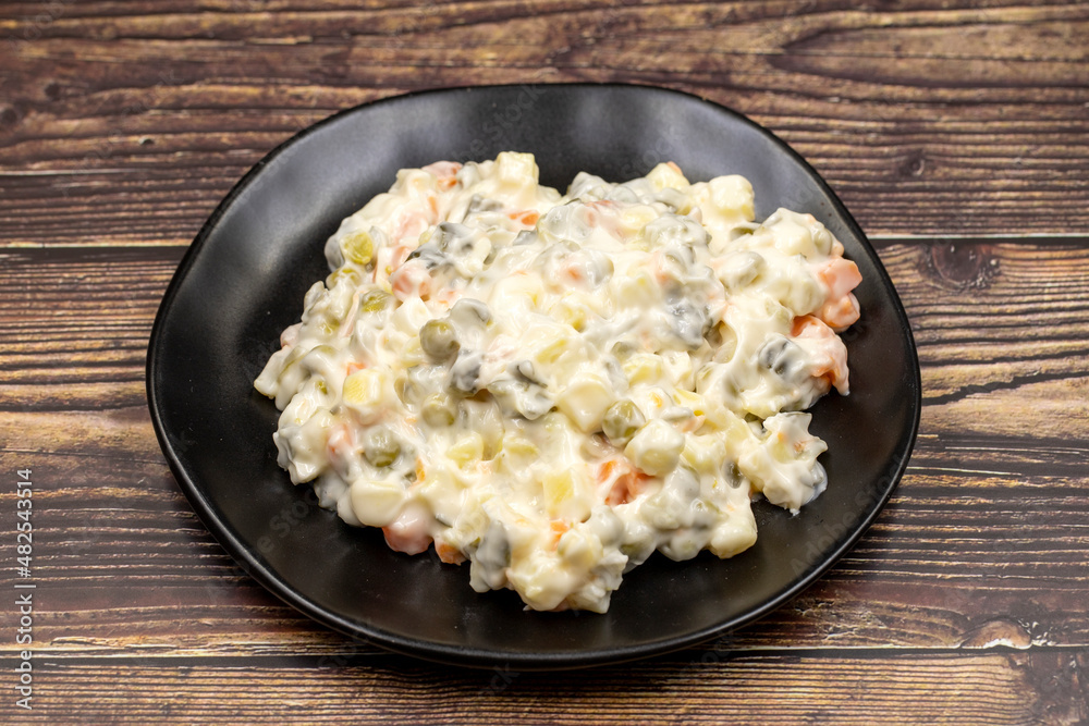 Potato salad with mayonnaise. Traditional salad with cooked vegetables with mayonnaise. Russian salad Potato salad with mayonnaise. Traditional salad with cooked vegetables with mayonnaise. Russian salad
