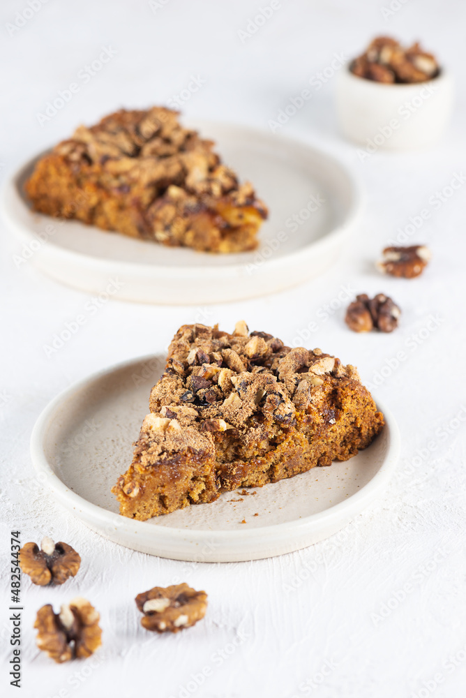 Homemade pie with tangerines and walnuts on a light table. Sugar, gluten and lactose free, vegan. Homemade pie with tangerines and walnuts on a light table. Sugar, gluten and lactose free, vegan.