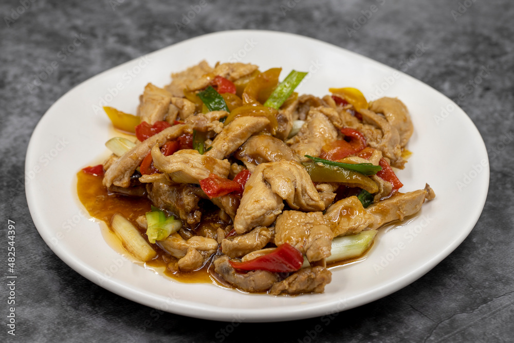 Chinese chicken dish. Chicken with olive oil and soy sauce. Traditional Chinese dish prepared with garlic, onion, capia pepper and green pepper Chinese chicken dish. Chicken with olive oil and soy sauce. Traditional Chinese dish prepared with garlic, onion, capia pepper and green pepper