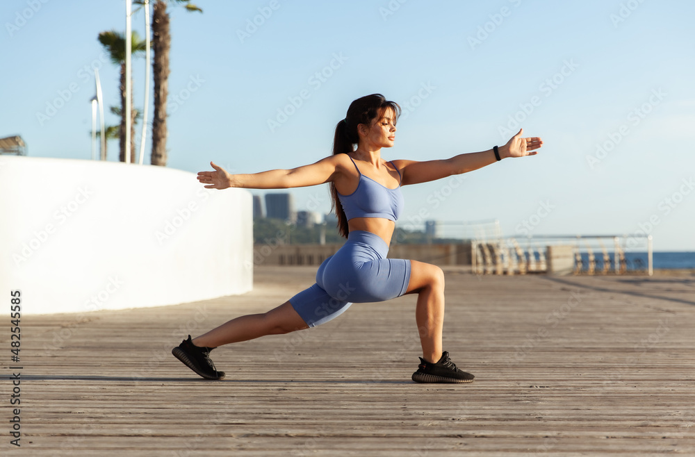 Young beautiful fit woman practicing yoga asana on the beach Young beautiful fit woman practicing yoga asana on the beach