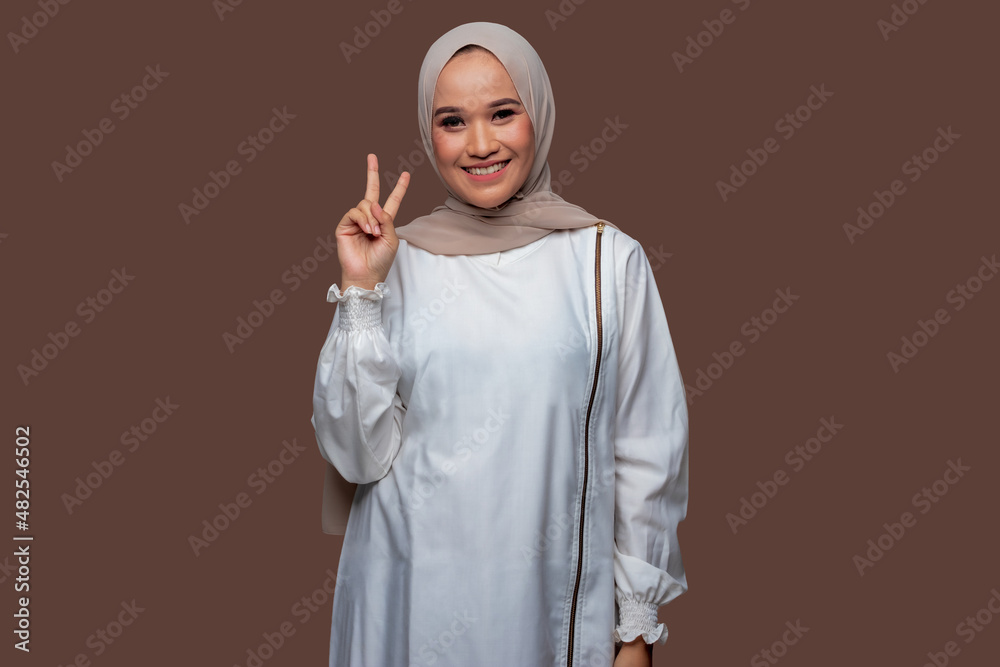 Muslim women with peaceful hand gestures isolated on plain background