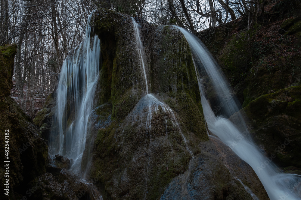 Waterfall texture. Background of the falling purest mountain water. A cascade of blurred movements. A natural neutral background for the design. The concept of life, ecology, environmental protection. Waterfall texture. Background of the falling purest mountain water. A cascade of blurred movements. A natural neutral background for the design. The concept of life, ecology, environmental protection.