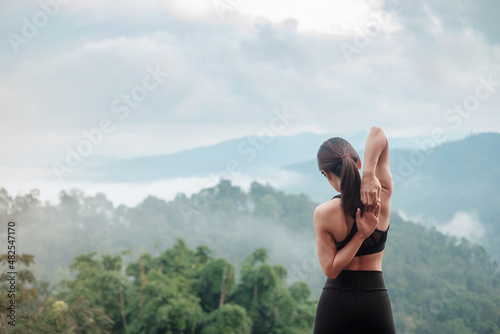 Fotografie athlete woman exercise in morning, Young fitness woman stretching muscle against mountain view, warm up ready for running or jogging