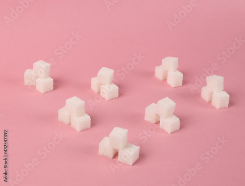 Pattern with cubes of sugar on a pink background