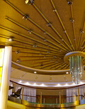 Close up detail abstract view of atrium foyer lobby interiors onboard modern luxury design Celebrity cruise ship cruiseship liner with furniture, lamps, chandeliers decoration fitting