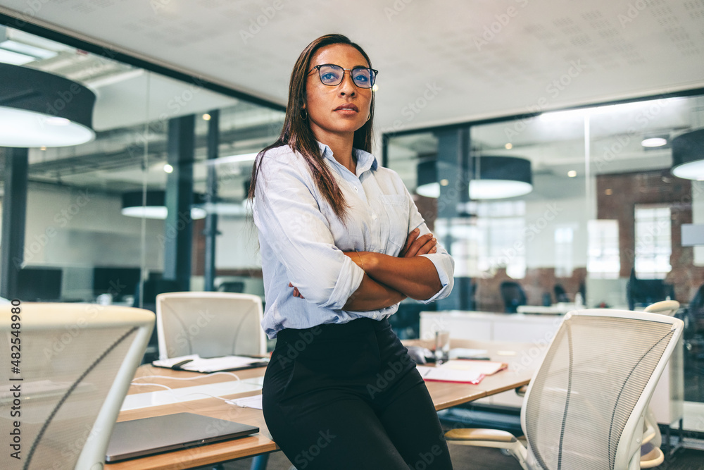 Confident black businesswoman looking thoughtful in a boardroom Confident black businesswoman looking thoughtful in a boardroom