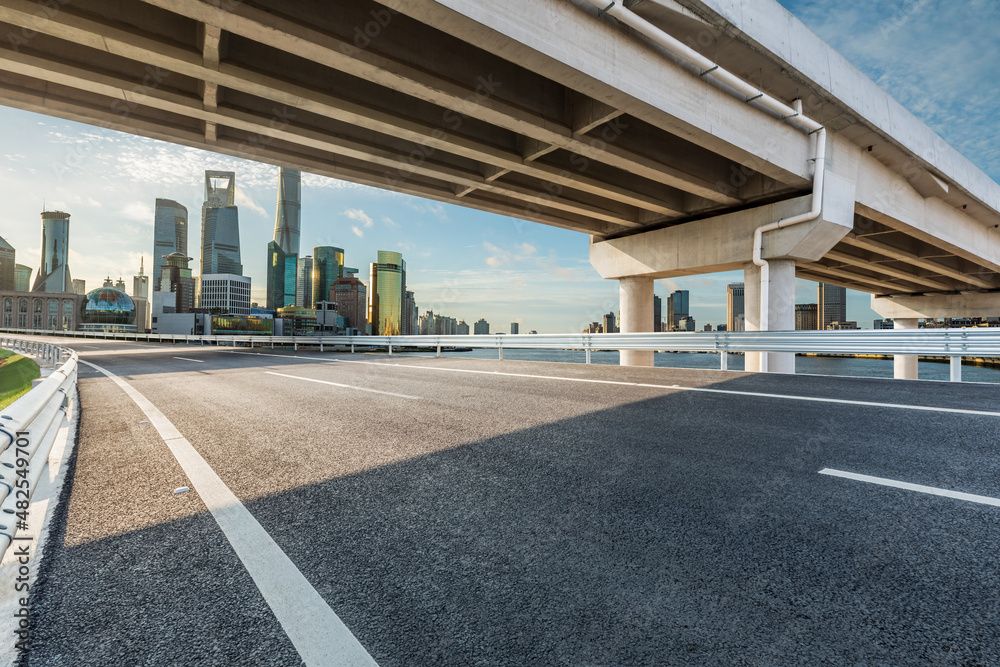 Empty asphalt road and city skyline with modern commercial buildings in Shanghai, China. Empty asphalt road and city skyline with modern commercial buildings in Shanghai, China.