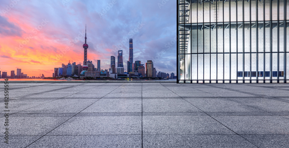 Empty square floor and city skyline with modern commercial buildings at sunrise in Shanghai, China. Empty square floor and city skyline with modern commercial buildings at sunrise in Shanghai, China.