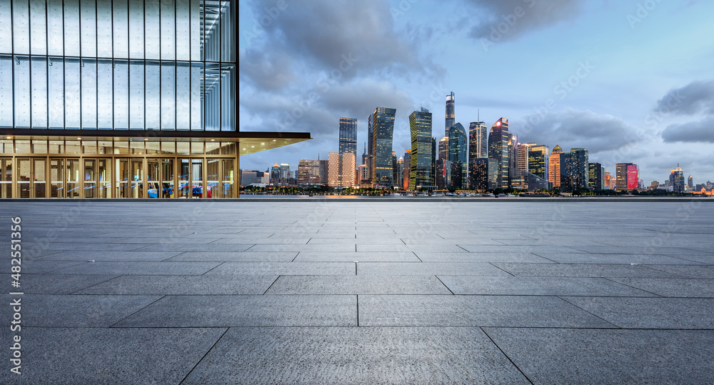 Fototapeta premium Panoramic skyline and modern commercial office buildings with empty square floor in Shanghai at night, China. empty road and cityscape.