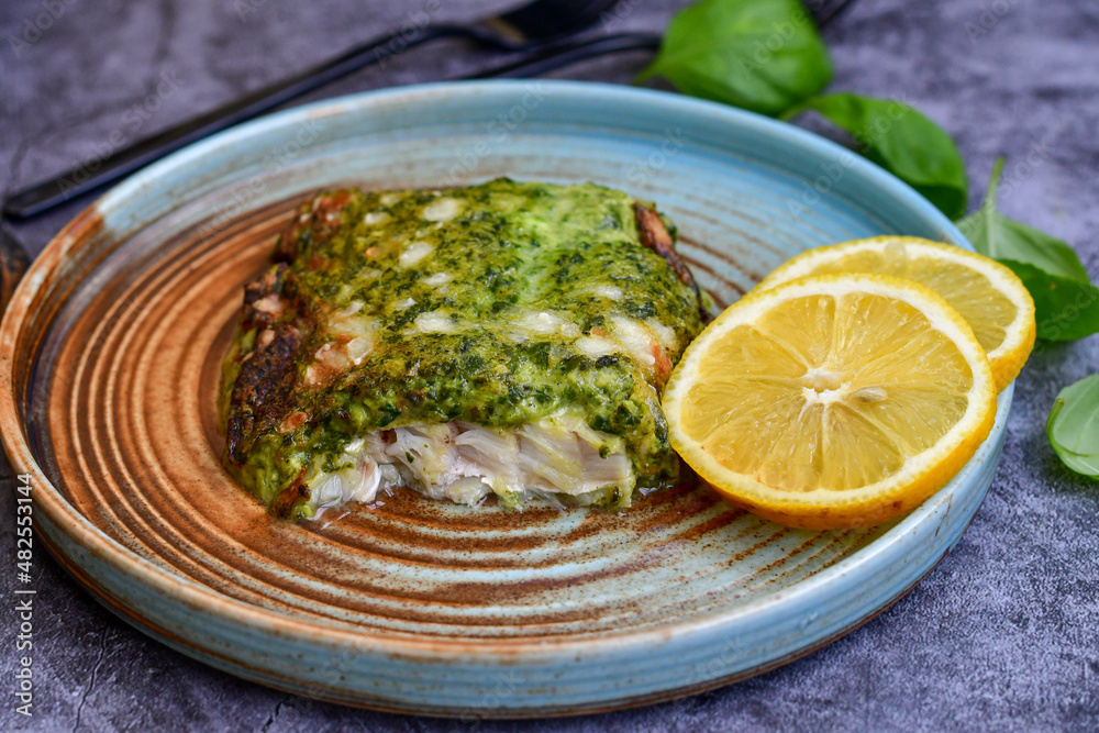Fish bake refined with spinach and gorgonzola cheese crust.White Code fish fillet stuffed with broccoli and creamy Alfredo sauce . Healthy food, delicious homemade italian lunch . Fish bake refined with spinach and gorgonzola cheese crust.White Code fish fillet stuffed with broccoli and creamy Alfredo sauce . Healthy food, delicious homemade italian lunch .