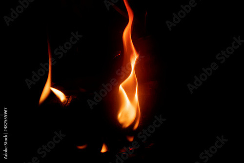 A tongue of flame bursting into flames. The budding of a fire. The flame looks like a burning candle. Copy space.