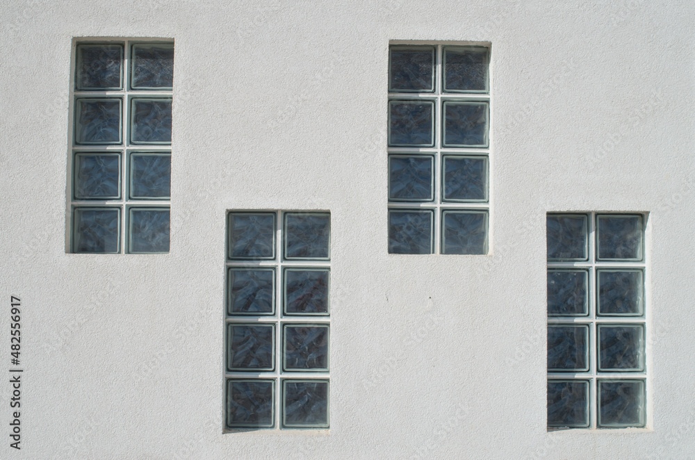 Four glass block windows looking outside on wall