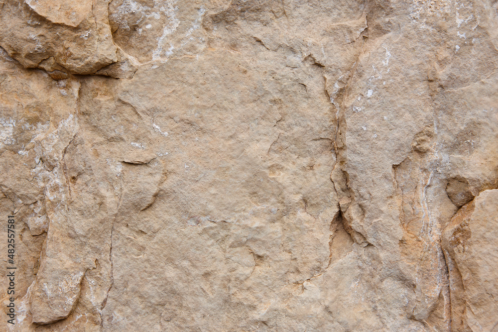Natural stone background detail in warm tone. Textured rock