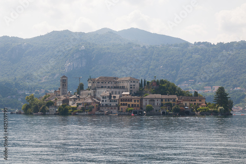 View of the world famous Orta San Giulio island, in the Orta Lake (piedmont, Northern Italy) seen from the top of Sacro Monte di Orta. UNESCO World Heritage Site
